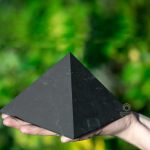 large shungite pyramid in hand